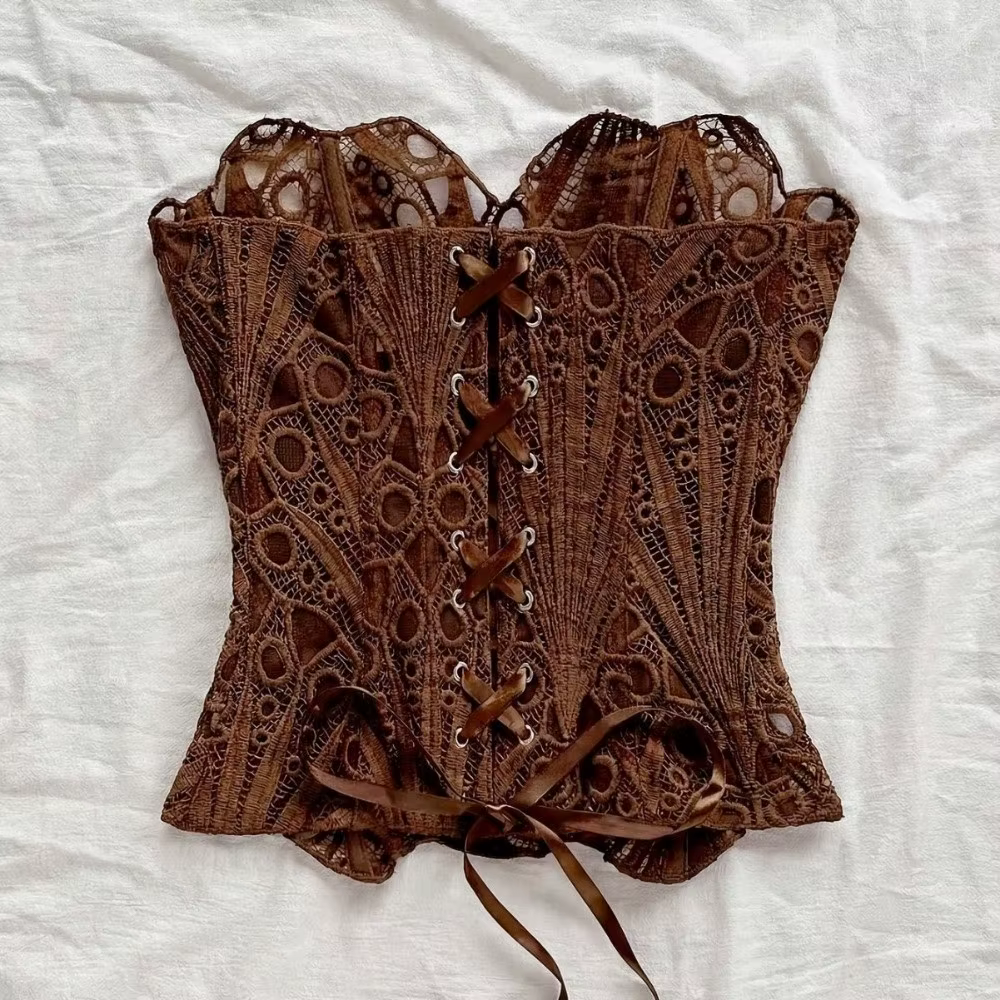 Haut corset amincissant à nouer au dos, ajouré, à ourlet asymétrique, avec dentelle à baleines et empiècements en maille, style bustier, pour tenue de club